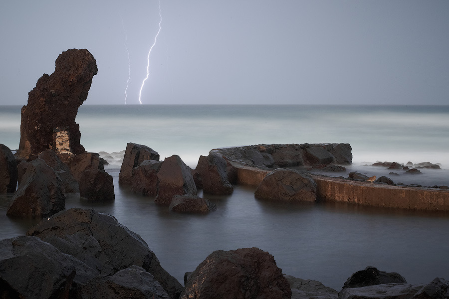 Coastal Ocean and lightning storm | stone in water, costal ocean, lighting, storm